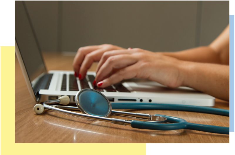 health care worker typing on a laptop computer