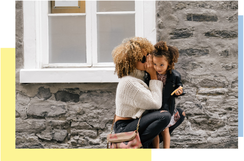 woman whispering to her daughter