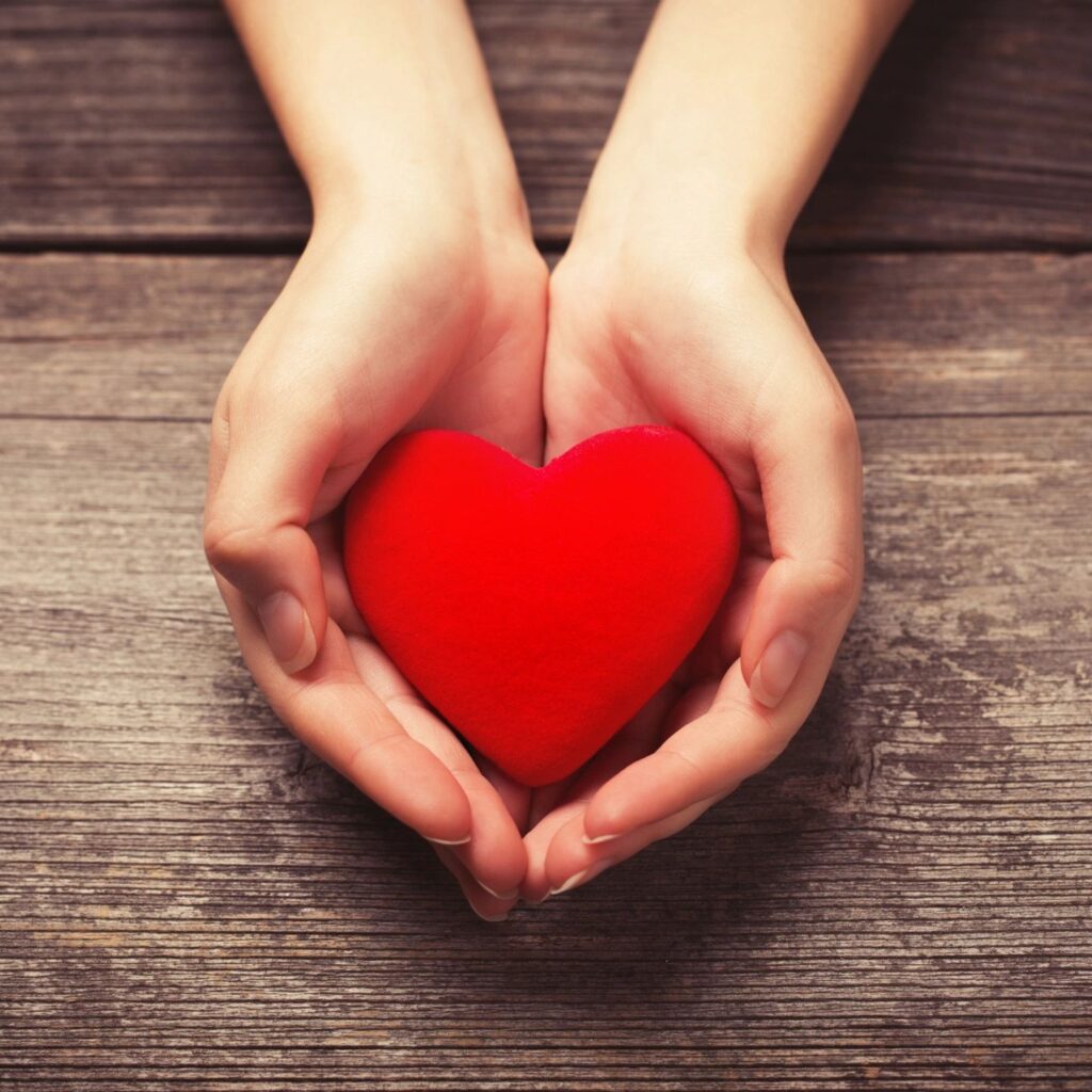 Hands holding red heart object